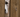 Golden Retriever peering through a fence looking anxious